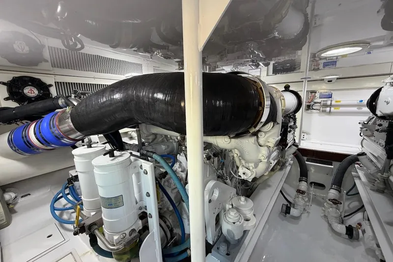 Slide: The Image of Engine room of a 2004 Viking 56 Convertible yacht, showcasing detailed machinery. - 38