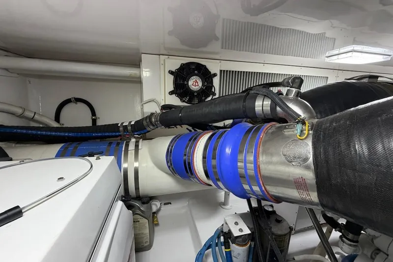 Slide: The Image of Engine room of a 2004 Viking 56 Convertible yacht, showcasing pipes and machinery. - 41