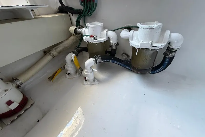 Slide: The Image of Engine room of 2004 Viking 56 Convertible yacht with visible filters and hoses. - 42