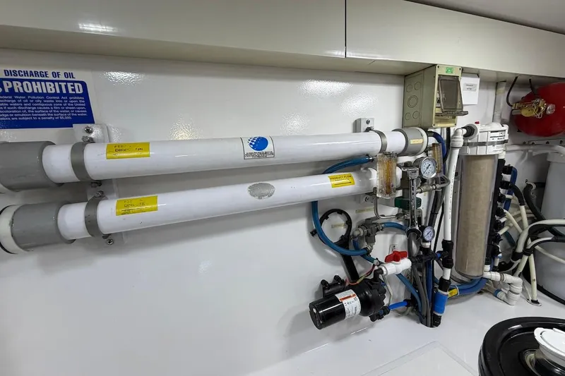 Slide: The Image of Engine room of 2004 Viking 56 Convertible yacht with complex piping and filtration system. - 46