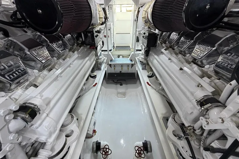 Slide: The Image of Engine room of a 2004 Viking 56 Convertible yacht, showcasing dual engines and clean layout. - 50