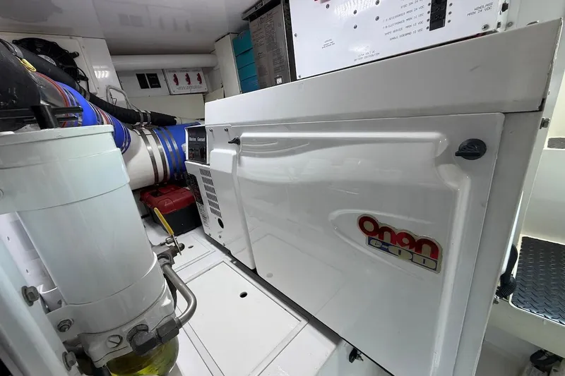 Slide: The Image of Engine room of 2004 Viking 56 Convertible with Onan generator and mechanical components. - 55
