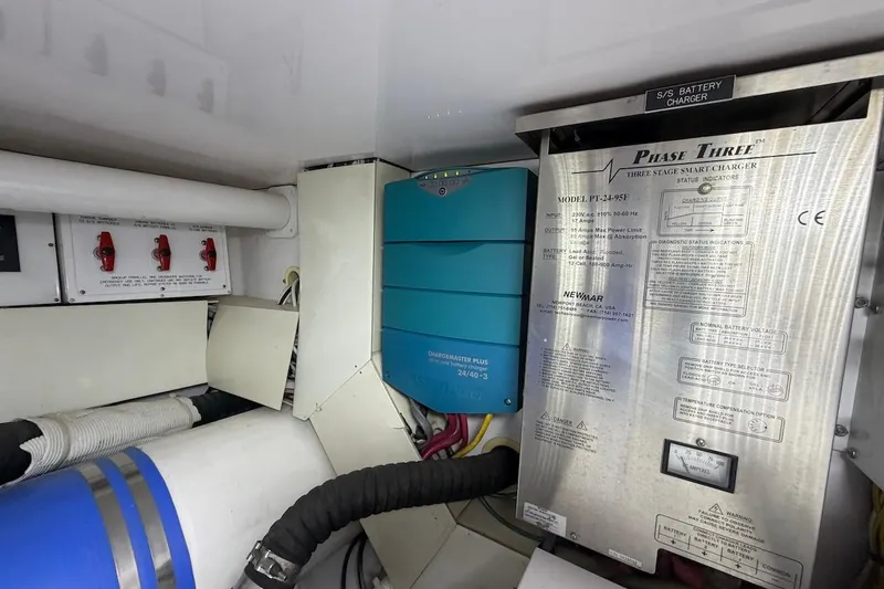 Slide: The Image of Engine room of 2004 Viking 56 Convertible with battery charger and electrical components. - 57