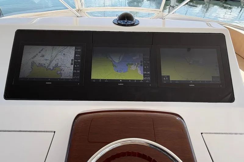 Slide: The Image of Dashboard of 2004 Viking 56 Convertible yacht with Garmin navigation displays. - 61