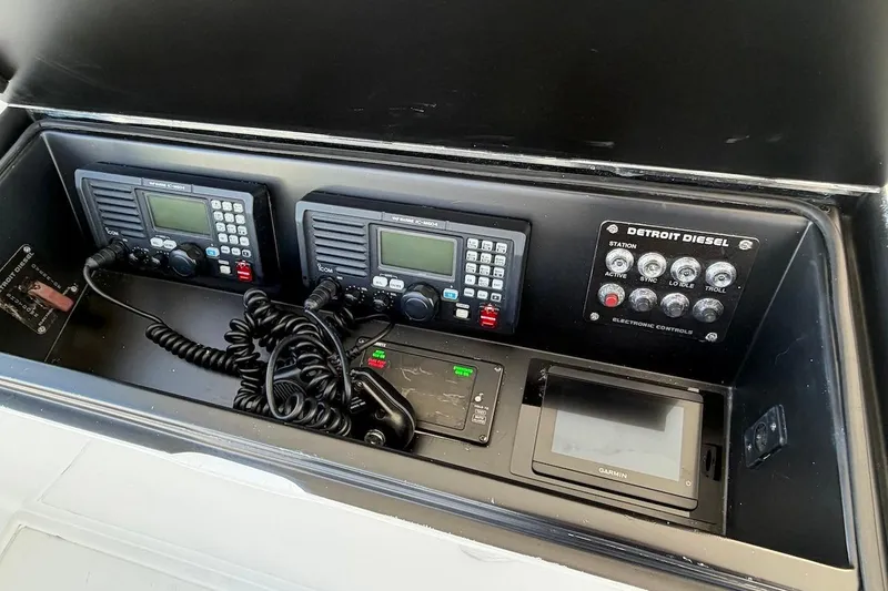 Slide: The Image of 2004 Viking 56 Convertible control panel with radios and Detroit Diesel electronic controls. - 62