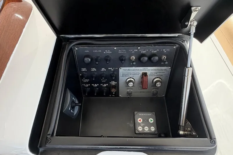 Slide: The Image of Control panel of a 2004 Viking 56 Convertible yacht, featuring various switches and buttons. - 63