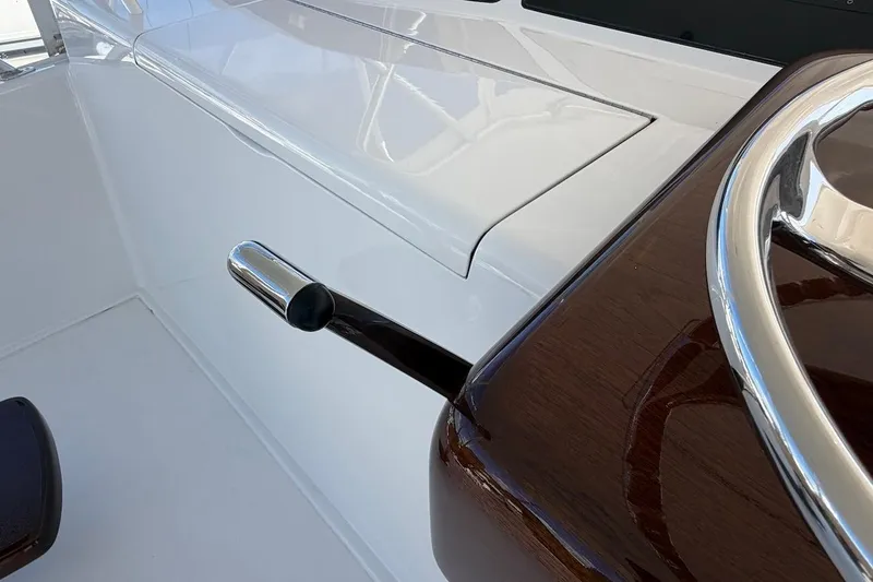 Slide: The Image of Close-up of 2004 Viking 56 Convertible yacht helm with polished wood and chrome details. - 64