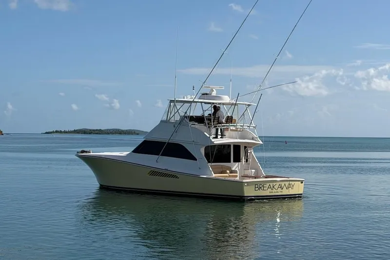Slide: The Image of 2004 Viking 56 Convertible yacht named "Breakaway" on calm ocean waters. - 8