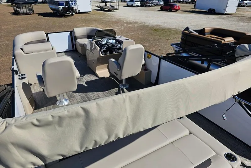 Slide: The Image of 2026 Bentley Pontoons Legacy 220 Swingback interior with beige seating and steering console. - 11