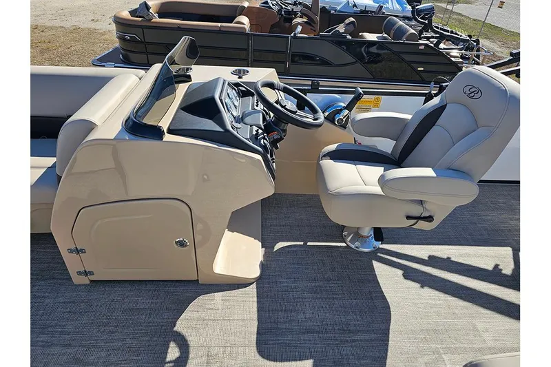 Slide: The Image of 2026 Bentley Pontoons Legacy 220 Swingback helm with luxurious captain's chair and control panel. - 16