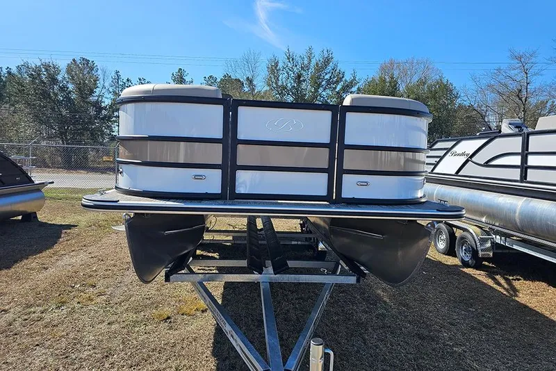 Slide: The Image of 2026 Bentley Pontoons Legacy 220 Swingback on trailer, displayed outdoors. - 4
