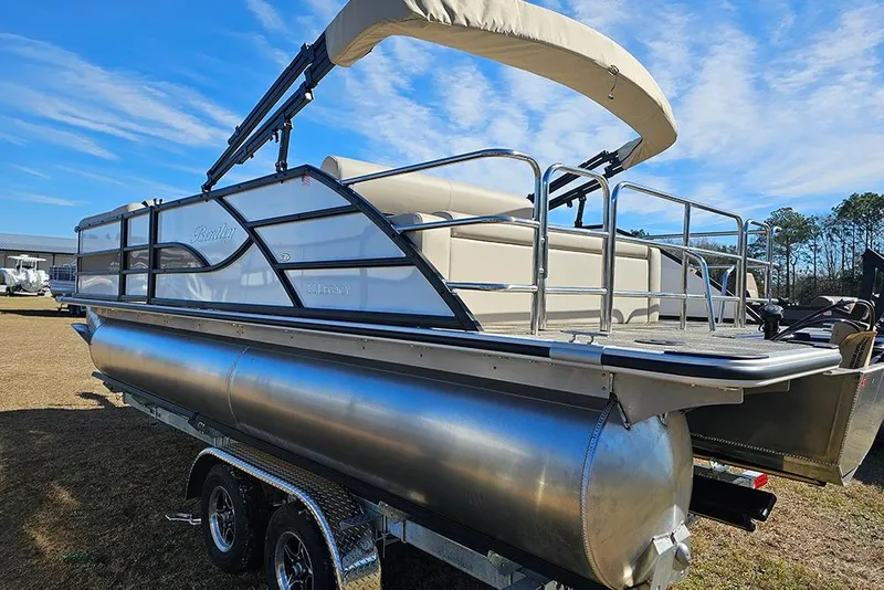 Slide: The Image of 2026 Bentley Pontoons Legacy 220 Swingback on trailer, under clear blue sky. - 7