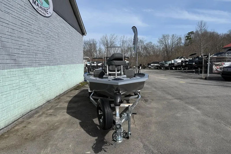 Slide: The Image of 2026 Xpress H20B Bay boat on trailer, parked outside a marine dealership. - 3