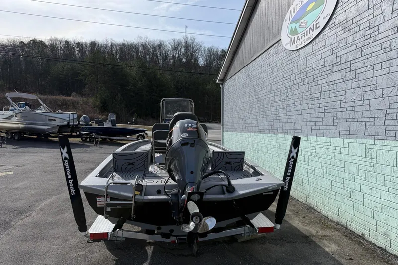 Slide: The Image of 2026 Xpress H20B Bay boat parked outside a marine shop. - 5