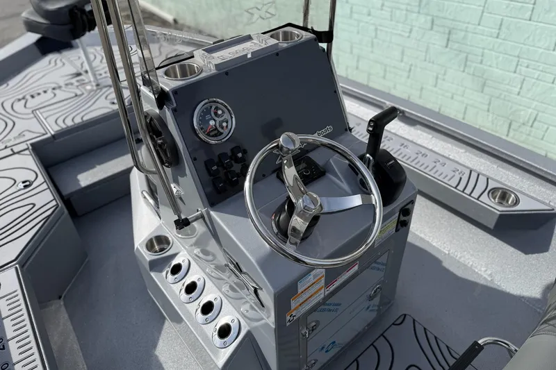 Slide: The Image of 2026 Xpress H20B Bay boat console with steering wheel and controls. - 9