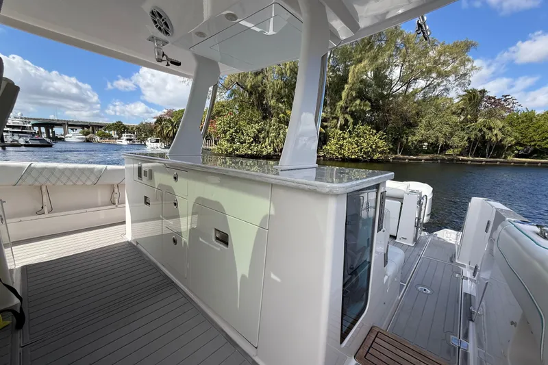 Slide: The Image of 2020 Regal 38 SAV yacht interior with sleek cabinetry and scenic waterfront view. - 15