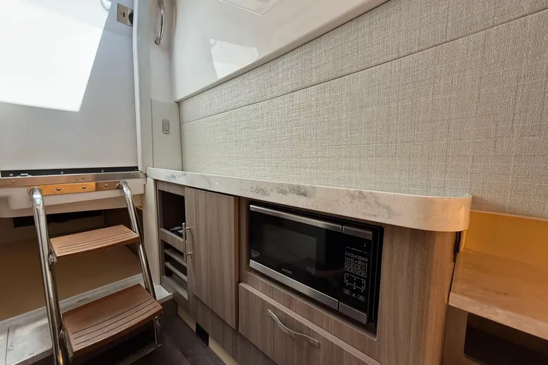 Slide: The Image of 2020 Regal 38 SAV yacht interior with microwave and wooden steps. - 19
