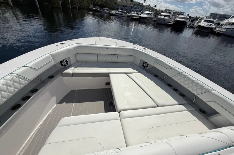 Slide: The Image of Luxurious seating area on a 2020 Regal 38 SAV boat, docked at a marina. - 26