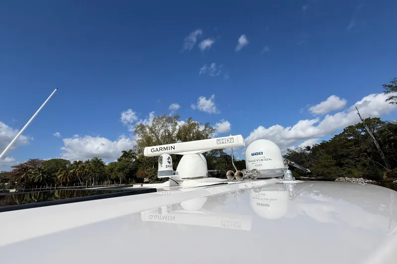 Slide: The Image of 2020 Regal 38 SAV boat with Garmin and TracVision equipment under clear blue sky. - 29