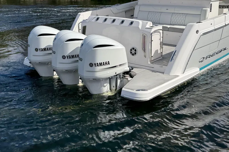 Slide: The Image of 2020 Regal 38 SAV boat with triple Yamaha outboard engines on water. - 8