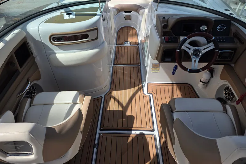 Slide: The Image of 2017 Crownline Eclipse E6 XS boat interior with elegant seating and wood-style flooring. - 12
