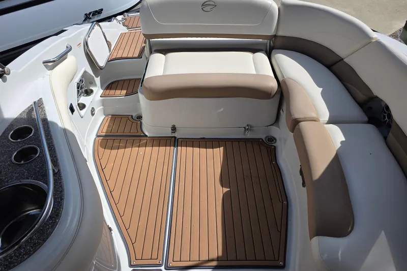 Slide: The Image of 2017 Crownline Eclipse E6 XS boat interior with cushioned seating and wood-style flooring. - 13
