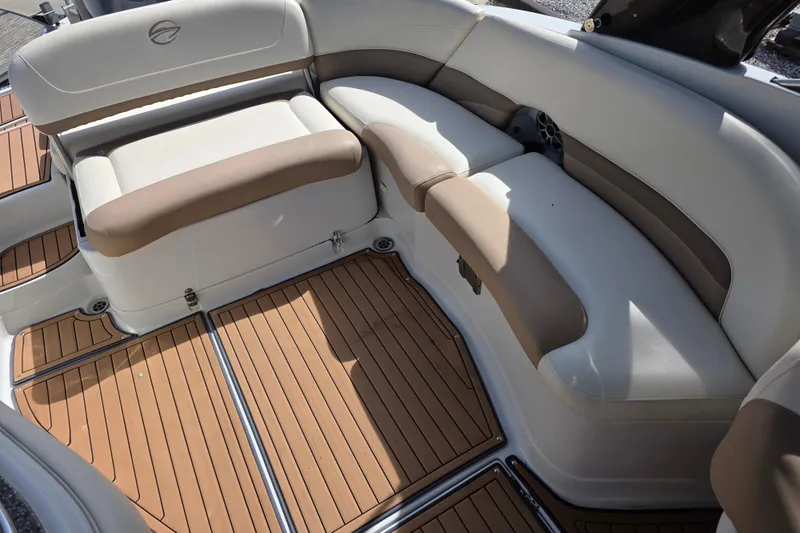 Slide: The Image of 2017 Crownline Eclipse E6 XS boat interior with cushioned seating and teak-style flooring. - 14