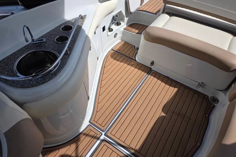 Slide: The Image of 2017 Crownline Eclipse E6 XS boat interior with sink, cup holders, and cushioned seating. - 15