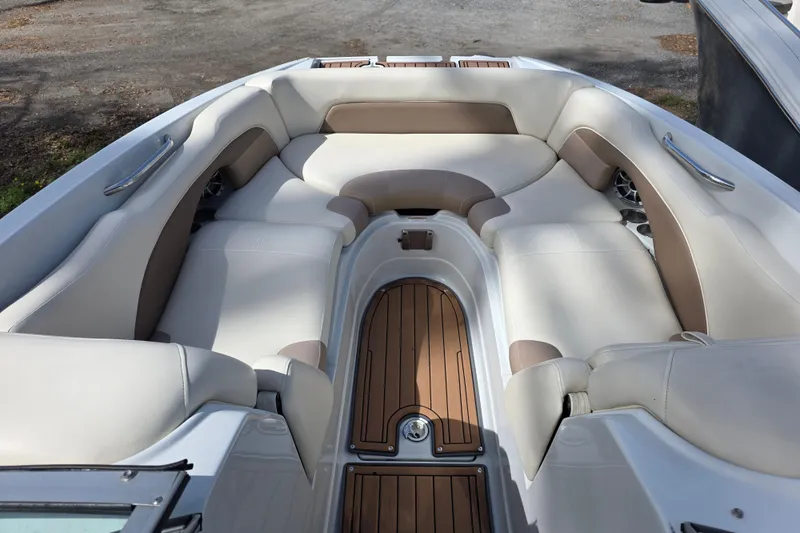 Slide: The Image of 2017 Crownline Eclipse E6 XS boat interior with spacious seating and wood accents. - 16