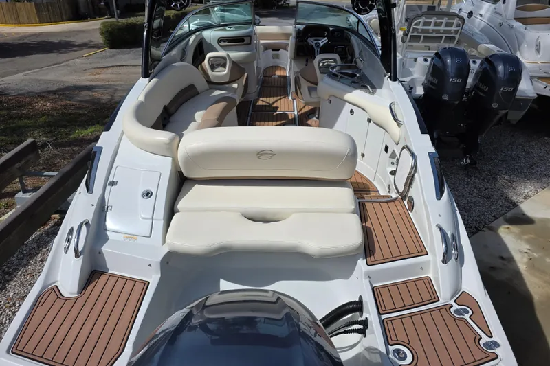 Slide: The Image of 2017 Crownline Eclipse E6 XS boat interior with luxurious seating and wood accents. - 5