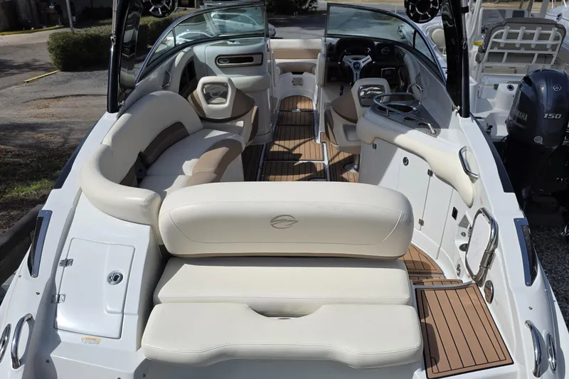 Slide: The Image of 2017 Crownline Eclipse E6 XS boat interior with beige seating and wood accents. - 6