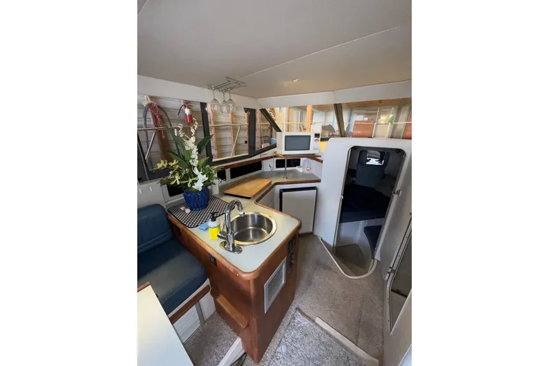 Slide: The Image of Interior of 1994 Carver 320 Voyager yacht with kitchenette and seating area. - 12