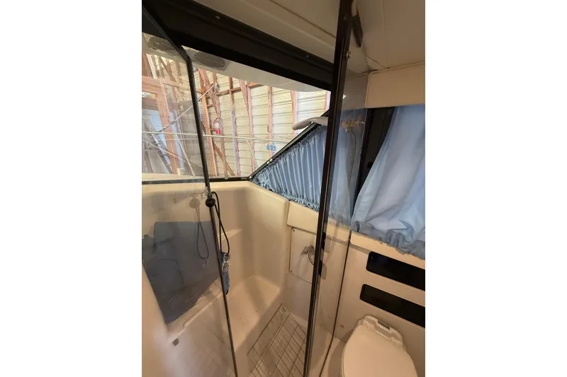Slide: The Image of Interior of 1994 Carver 320 Voyager boat bathroom with shower and toilet. - 15
