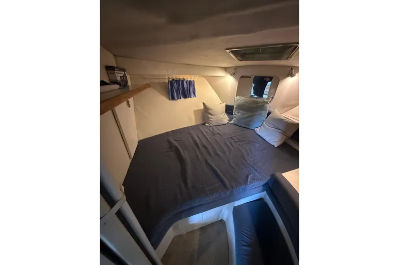 Slide: The Image of Cozy cabin interior of 1994 Carver 320 Voyager with bed and pillows. - 16