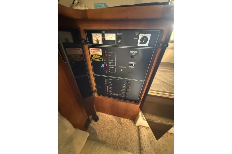 Slide: The Image of 1994 Carver 320 Voyager control panel with gauges and warning labels. - 19