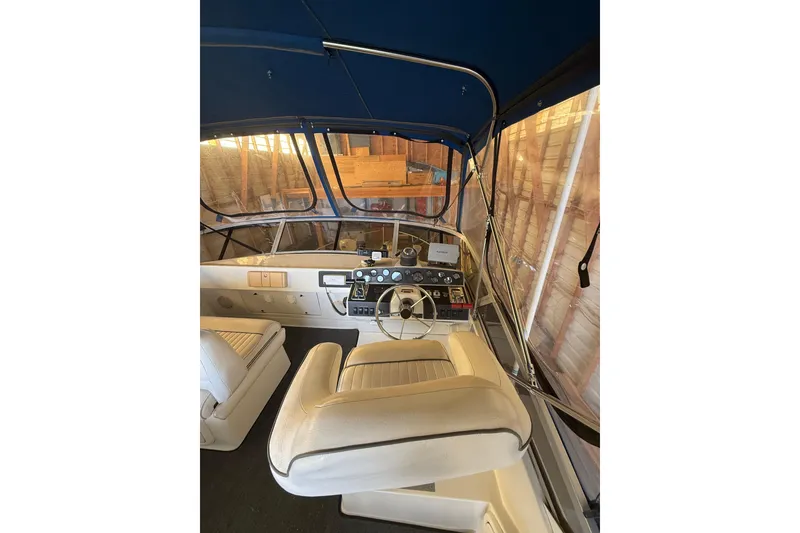 Slide: The Image of Interior view of 1994 Carver 320 Voyager boat cockpit with steering wheel and seating. - 21