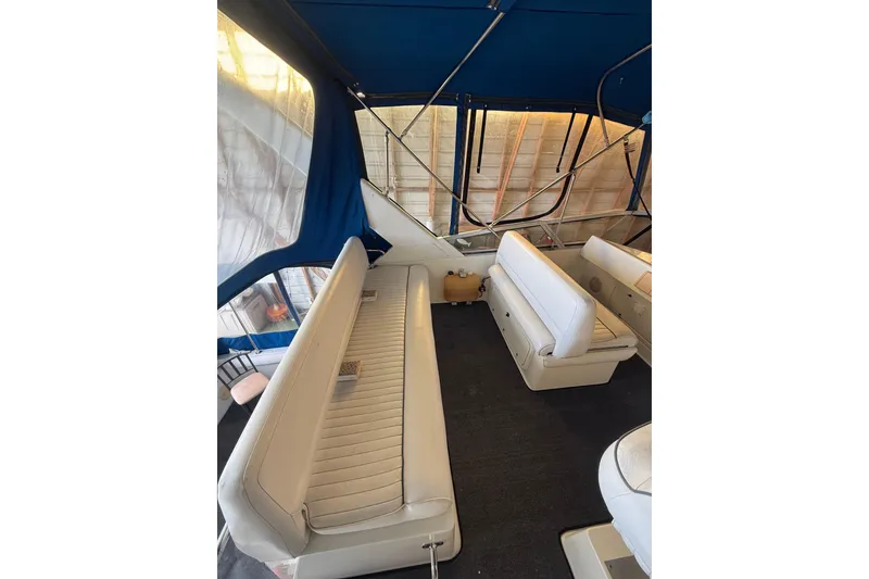 Slide: The Image of 1994 Carver 320 Voyager interior with white seating and blue canopy. - 22