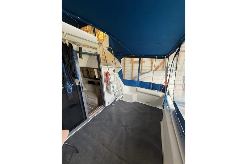 Slide: The Image of 1994 Carver 320 Voyager interior with blue canopy and seating area. - 6