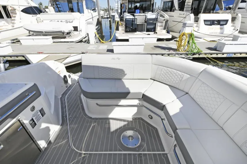 Slide: The Image of 2022 Sea Ray Sundancer 320 yacht interior with elegant seating at marina. - 10