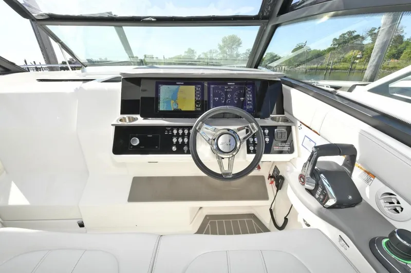 Slide: The Image of 2022 Sea Ray Sundancer 320 helm with modern navigation and control systems. - 12