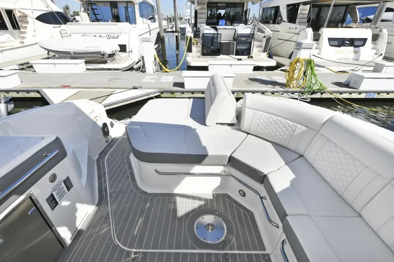 Slide: The Image of 2022 Sea Ray Sundancer 320 yacht interior with luxurious seating at marina. - 15