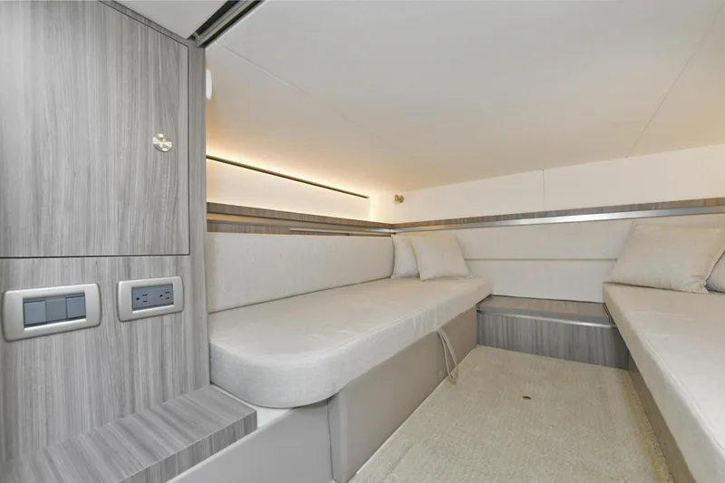 Slide: The Image of 2022 Sea Ray Sundancer 320 cabin interior with modern seating and wood paneling. - 21