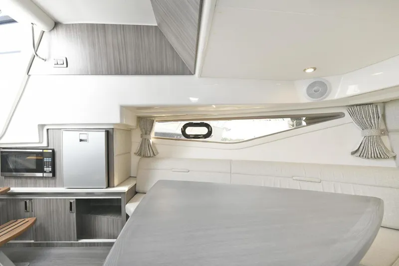 Slide: The Image of Luxurious interior of 2022 Sea Ray Sundancer 320 yacht with modern kitchen amenities. - 22