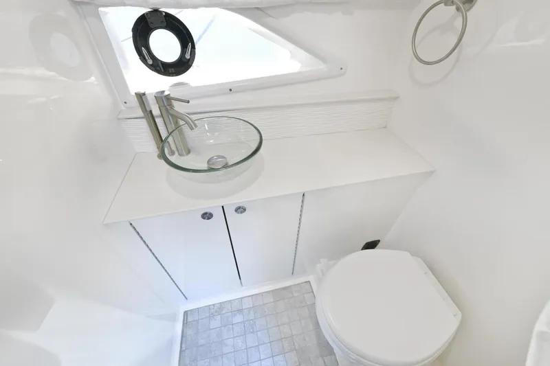 Slide: The Image of Modern bathroom in 2022 Sea Ray Sundancer 320 yacht with glass sink and toilet. - 23