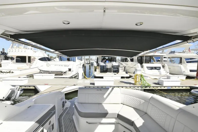Slide: The Image of 2022 Sea Ray Sundancer 320 yacht interior with docked boats in marina. - 6