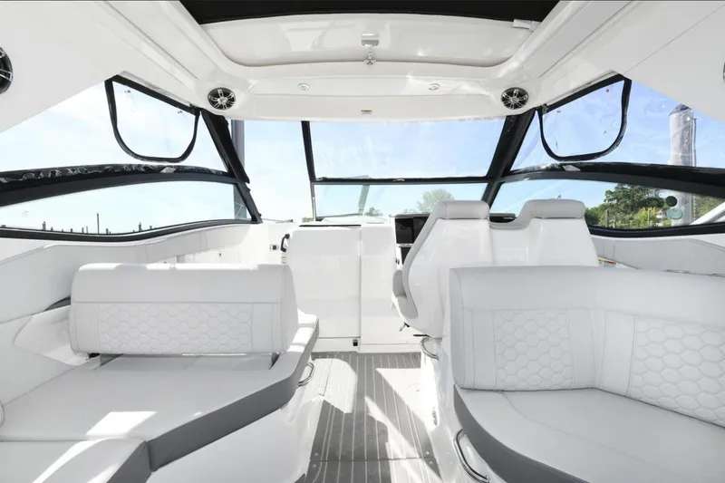 Slide: The Image of 2022 Sea Ray Sundancer 320 interior with modern white seating and panoramic windows. - 7