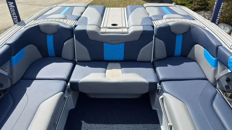 Slide: The Image of Interior of 2022 MasterCraft XT24 boat with blue and gray seating. - 12