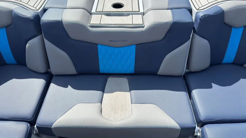 Slide: The Image of MasterCraft XT24 2022 boat seat with blue and gray upholstery. - 16