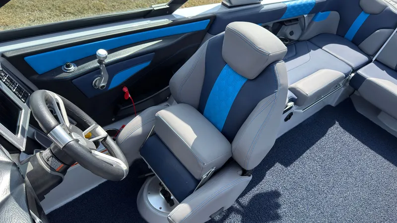 Slide: The Image of Interior of a 2022 MasterCraft XT24 boat with blue accents. - 24