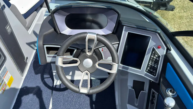 Slide: The Image of Interior of 2022 MasterCraft XT24 with steering wheel and dashboard. - 25